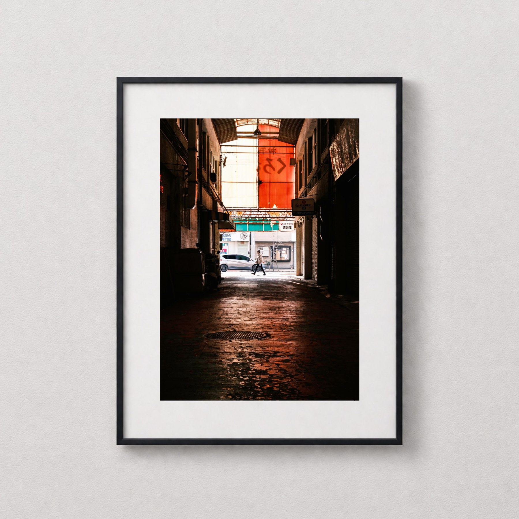 Through shown in a black frame against a grey wall.